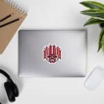 Traditional Sri Lankan yaka sticker decor on a laptop with plant and stationery