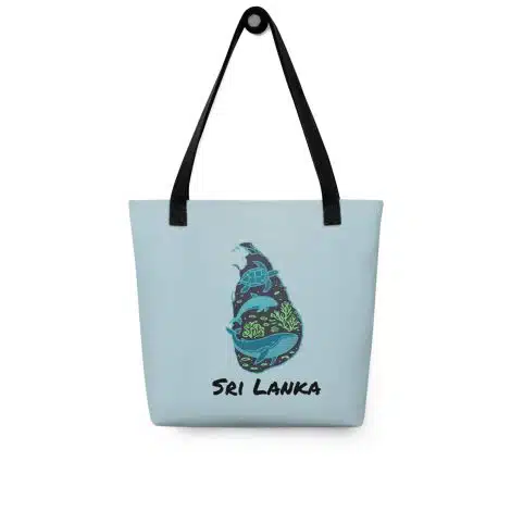 Woman carrying the stylish deep blue Sri Lanka Tote Bag over her shoulder on a sunny day.